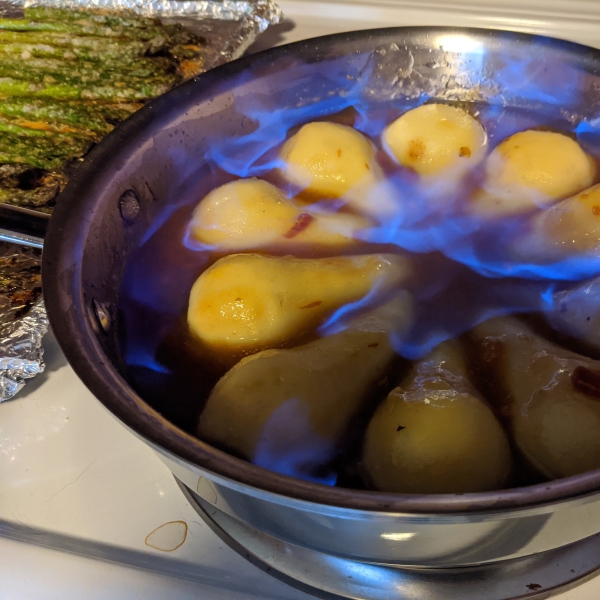 Flambeed Vanilla-Poached Pears with Apricot Sauce